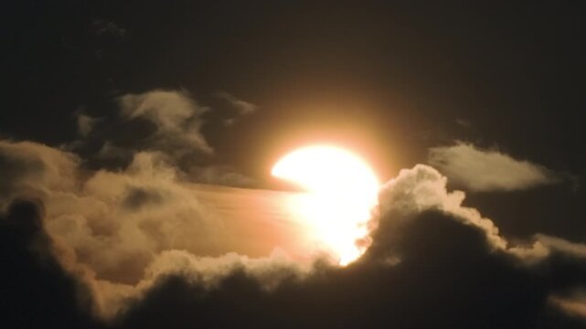 Breathtaking partial solar eclipse of August 12, 2026, featuring the sun passing through dramatic clouds, creating a celestial spectacle of light and shadow