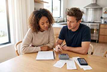 Fototapeta premium Couple budgeting purchases at kitchen table with smartphone and receipts