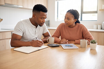 Fototapeta premium Black Couple Reviewing Household Budget at Kitchen Table