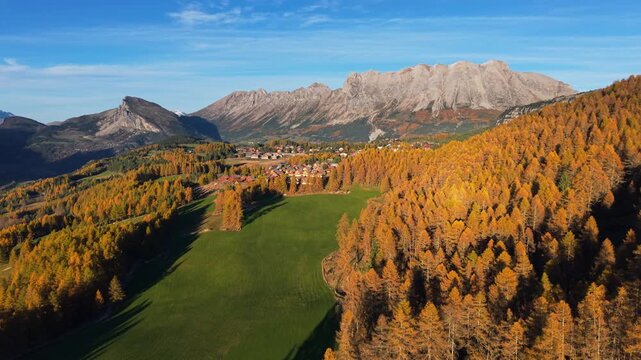 Aerial view of La Joue du Loup ski resort in autumn, surrounded by colorful larch forests and alpine landscape of the Devoluy Massif. Hautes-Alpes, French Alps, France