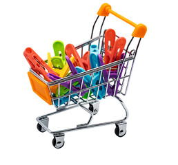 Miniature shopping cart holding colorful laundry clothespins © Leo