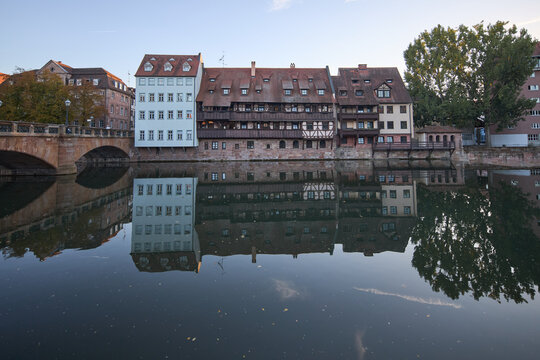 Historic timber-framed houses along the Pegnitz river in Nuremberg at golden hour sunset light