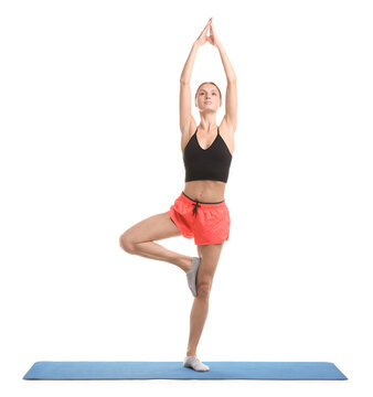 Young woman practicing yoga on fitness mat against white background