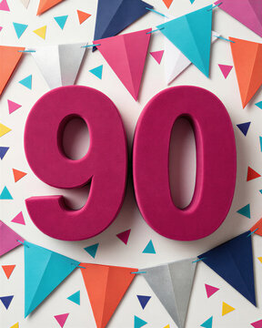 Large pink 90 surrounded by colorful triangular flags and confetti on white.