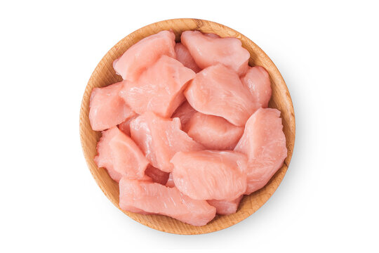 Raw diced chicken fillet in wooden bowl isolated on white background. Top view. Flat lay