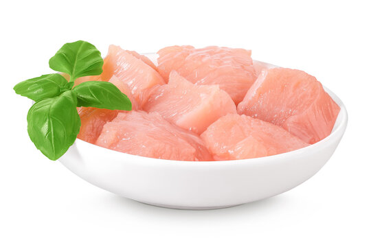 Raw diced chicken fillet in ceramic bowl isolated on white background. Top view. Flat lay