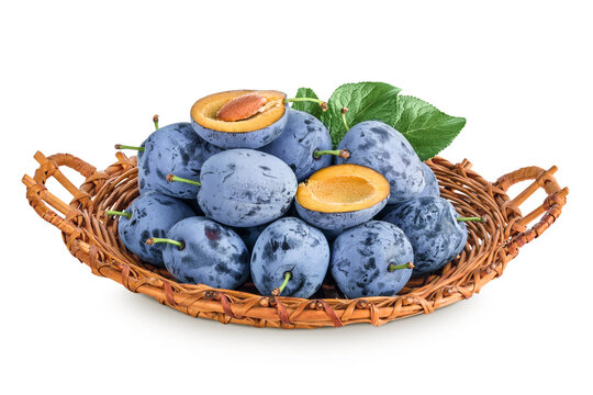 fresh blue plum in wicker basket isolated on white background.