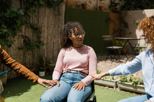 Women supporting each other during group therapy session