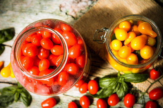 red and yellow cherry tomatoes in a jar for winter