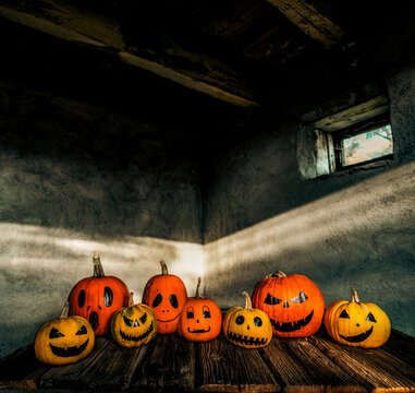 scary funny Halloween pumpkins on wooden table