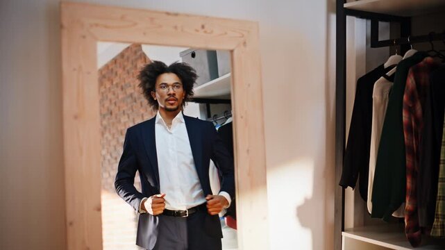 Client adjusting suit jacket mirror. Businessman checking fit boutique store.