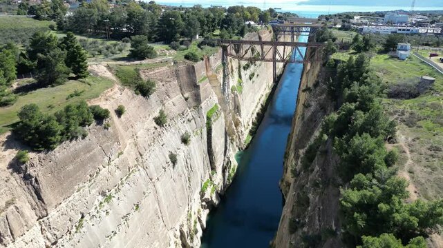 Aerial backward drone shot of Corinth Canal cliffs and bridges in Greece 4K 60fps