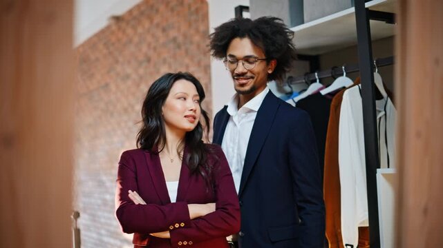 Fashion boutique owner team smiling camera. Small business partner showroom.