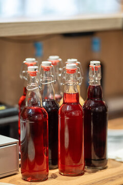 Glass swing-top bottles filled with red and dark berry beverages