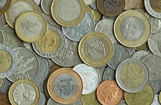 Large amount of different coins from various money currencies. Treasure and numismatics concept