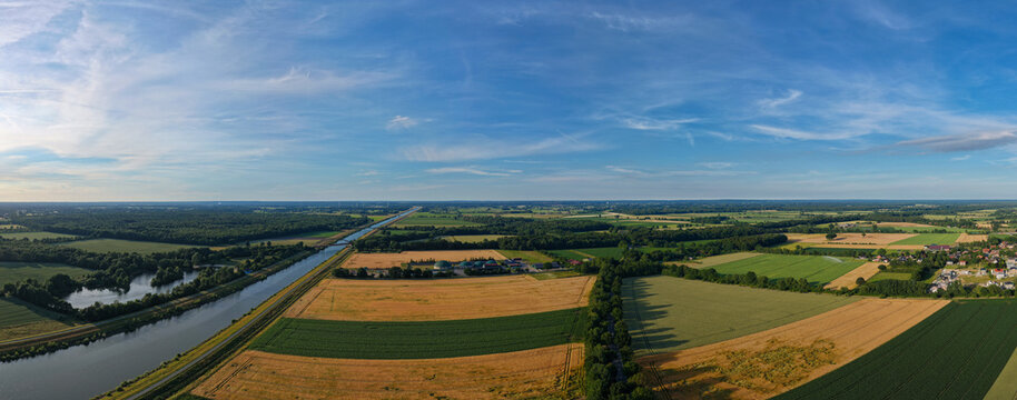 Aerial river canal landscape. Panoramic landscape with river canal in farming countryside. River canal aerial panorama. Panoramic aerial canal with field. Farming rural field landscape panorama