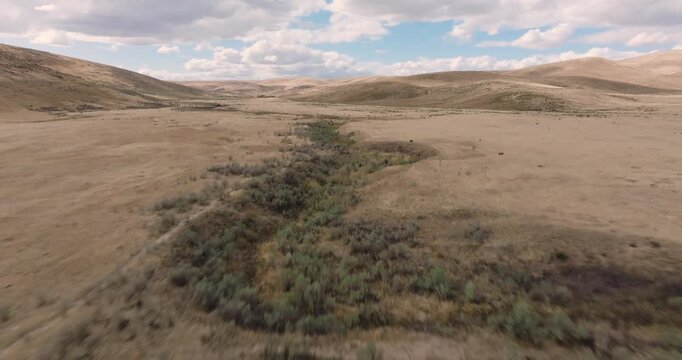Drone footage captures winding road through arid terrain