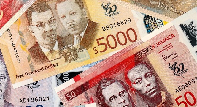 Jamaican dollar money bills in pile on table. Jamaica JMD currency cash close up