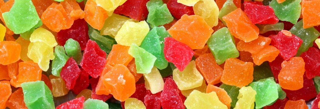 Marmalade candies of different colors texture close up top view. Coloured marmalade cubes
