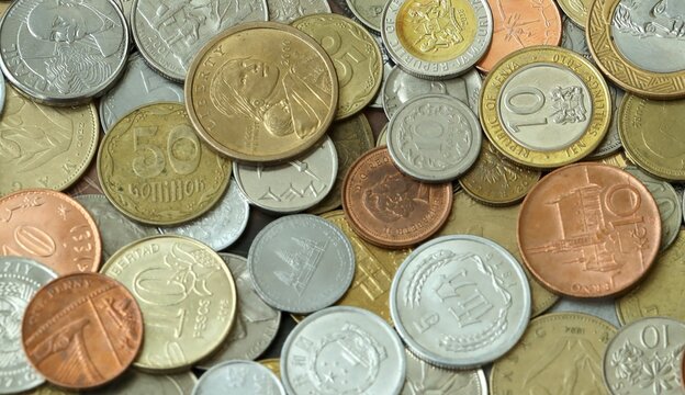 Large amount of different coins from various money currencies. Treasure and numismatics concept