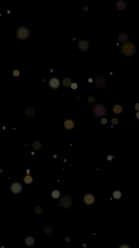 Vertical bokeh overlay loop black background warm pink glowing lights ideal for screen blending over live action clips title cards social media edits posters brochures and event promo layers