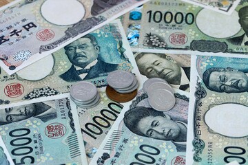 Japanese yen money banknotes and coins on table. Japan cash bills of JPY currency © Viktor