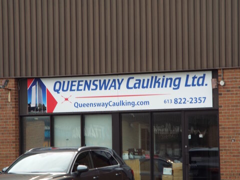 Gloucester, Ontario, Canada &ndash; July 27, 2026: The "Queensway Caulking Ltd." storefront features an overhead sign with contact details, glass entrance, brick exterior, and a parked car  at 5370 Canotek 