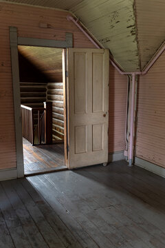 Vertical interior shot of doorway and stairwell with shadows