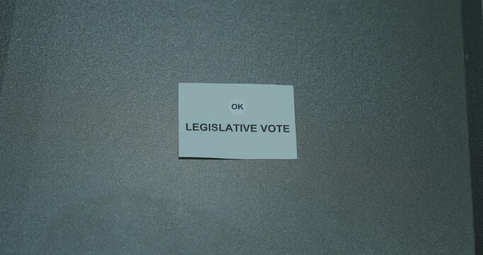 Legislative vote text on a white paper card against a gray background, representing parliamentary decisions, democracy and lawmaking