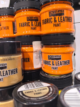 Bright orange fabric and leather paint displayed on store shelves