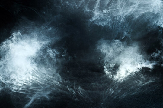 Smoke mist swirling forming abstract dark background texture