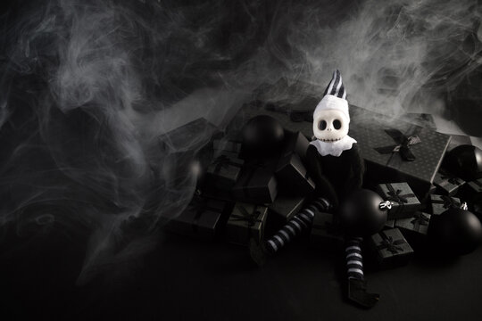 Skeleton elf sitting on dark holiday gifts with smoke