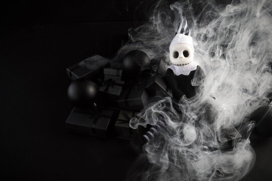 Skeleton clown toy with black gifts in smoke