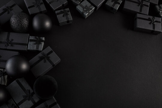 Black gift boxes and ornaments creating dark elegant background