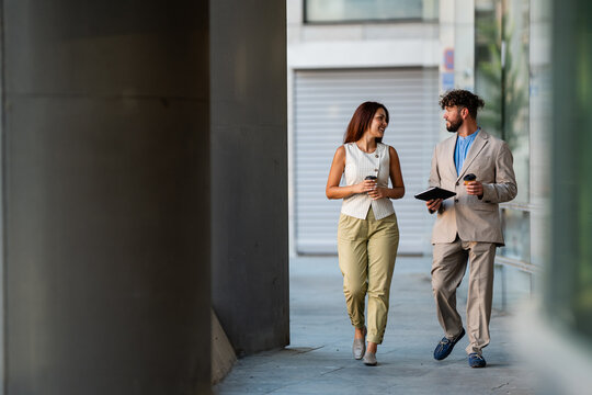 Business colleagues walking and discussing outdoors