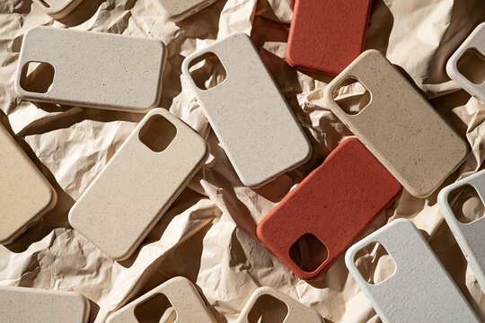 Eco-friendly phone cases arranged on crumpled paper
