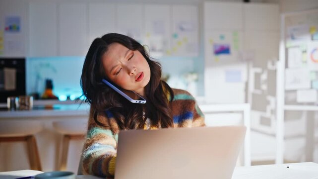 Remote worker phone call home kitchen office. Woman laughing business laptop.