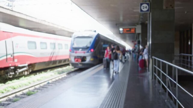 Blurred train scene with shallow bokeh and soft defocused lights and rails, station; background backplate template calm.