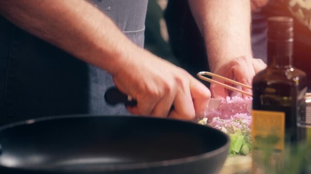 Kitchen chef prepping food and cooking vegetable ingredients in restaurant. A professional cook is a tradesperson proficient in food preparation.
