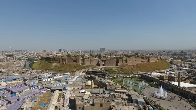 Wide aerial view of the Erbil Citadel rising above the city center and Shar Park, Kurdistan