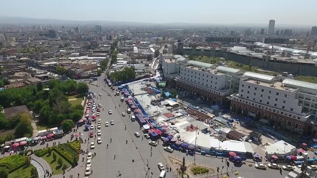 Aerial view of busy roundabout and market stalls near the old bazaar in Erbil city center