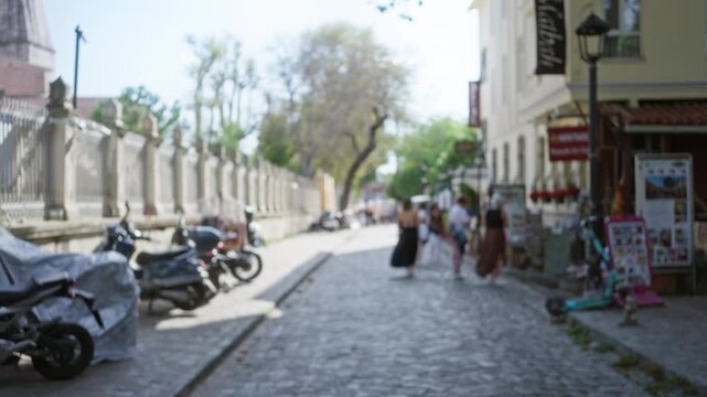 Sunlit istanbul historic cobblestone street soft defocused street; background backplate copyspace calm.