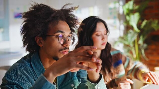 Close up man rubbing eyes taking off glasses. Multiracial startup coworkers.