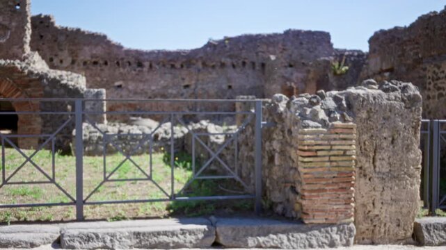 Blurred pompeii ruins with shallow bokeh and textured brick wall, outdoor; background backplate copyspace.
