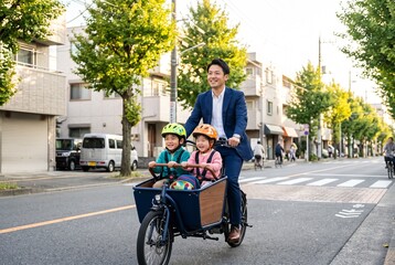 Obraz premium Businessman Father Dropping Kids on Cargo Bike