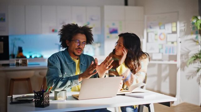 Startup pair brainstorming home office. Man explaining idea female colleague.