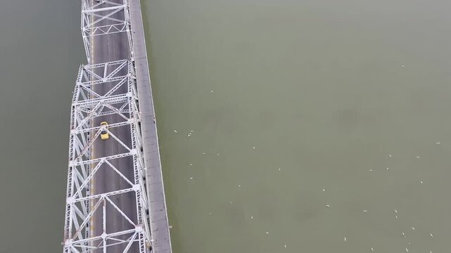 Overhead drone shot of traffic crossing the Al-Sarafiya iron bridge over the Tigris, Baghdad, Iraq