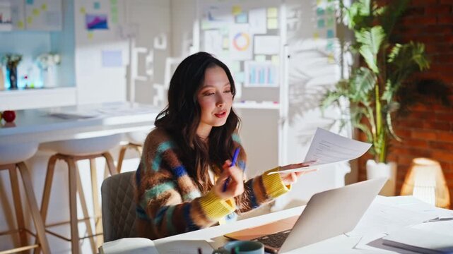 Business woman explaining documents video call laptop. Frustrated home office.