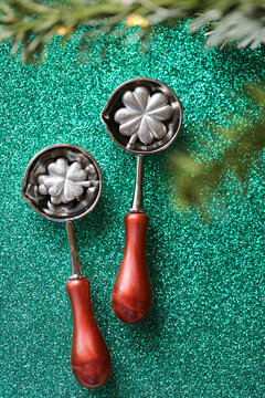 Spoon with Clover Stamp Design. metal casting set on green glitter for tin pouring instructions,holiday gift sets,good luck and traditional European holiday rituals.Metal Melting Spoons with Lucky