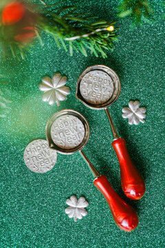 New Year predictions and traditional tin casting on Green Glitter Background for tin pouring instructions,holiday gift sets and New Year fortune telling activities.New Years Eve sparkling background
